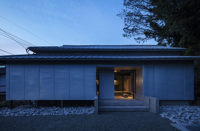 The façade of “House of local spirits” glowing in the evening light - Kenta Hasegawa