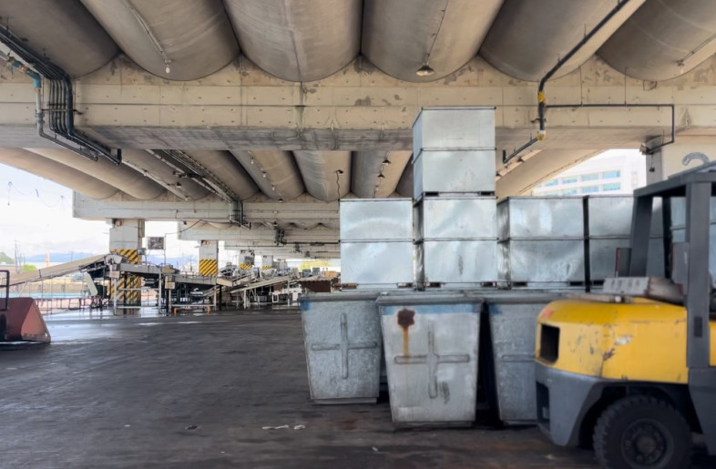 Stacks of metal fish boxes at the port, inspiring the project’s design language - atelier SALAD