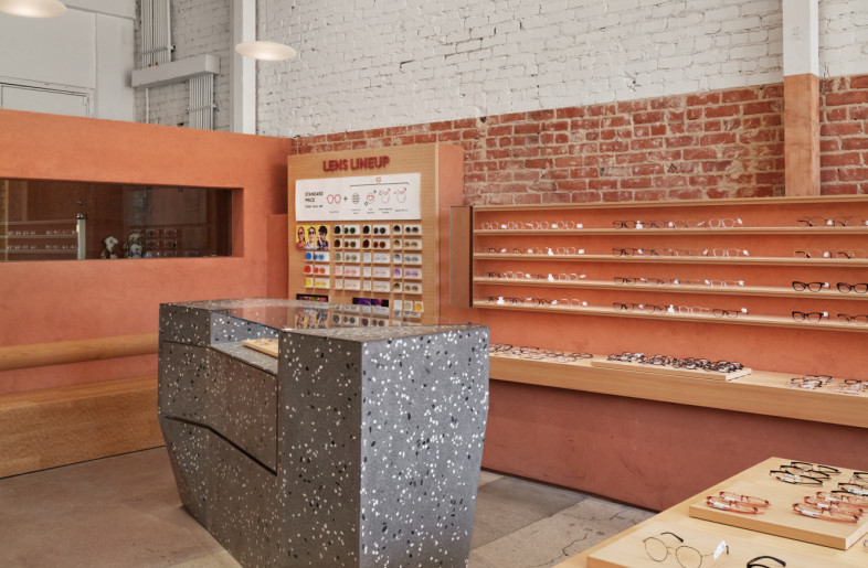 At the back of the store are the Transaction Table, Lens Lineup, and a bench featuring a traditional Japanese carving pattern. The Transaction Table, in particular, adopts a geometry reminiscent of rocks in a Japanese garden, adding a touch of playfulness to the serenity of the space. - Daici Ano