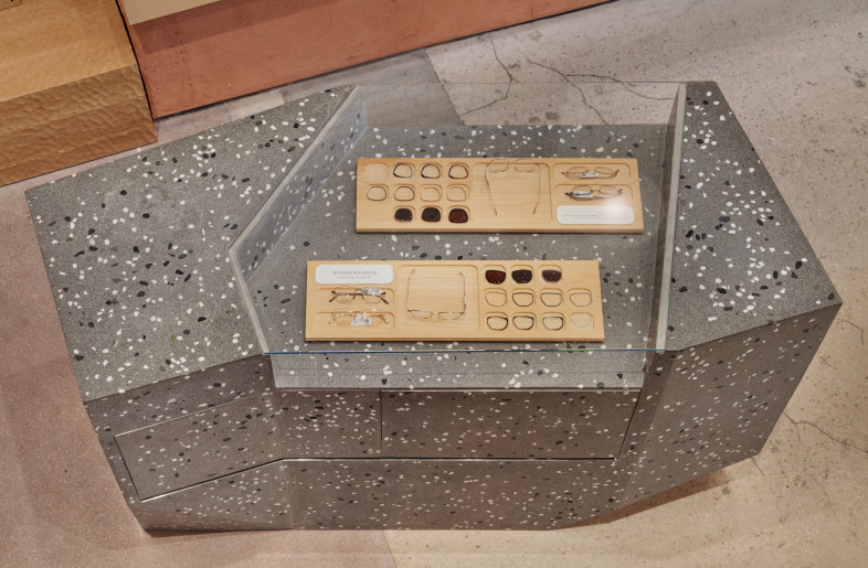 The terrazzo transaction table, composed of large gray aggregates, contrasts with the warmer materials around it, evoking the calm and contemplative spirit of a traditional Japanese stone garden. - Daici Ano
