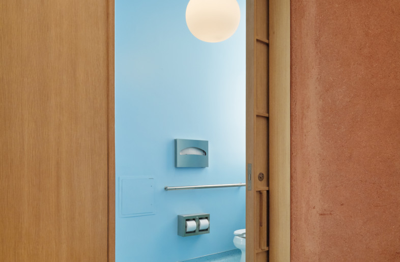 The restroom is unified in blue, creating a calm and immersive space that pleasantly surprises customers with its strong contrast to the store’s warm natural materials. - Daici Ano