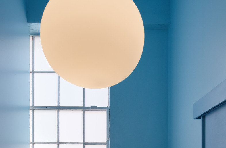 Shoji-style translucent screen offers both privacy and a gentle wash of natural light in the all-blue restroom. - Daici Ano