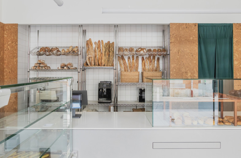 A restrained colour palette of toasted orange-brown, French grey and viridian feature throughout, from the exterior of the shop to the stock shelves and bakery counter. - Emmy Martens