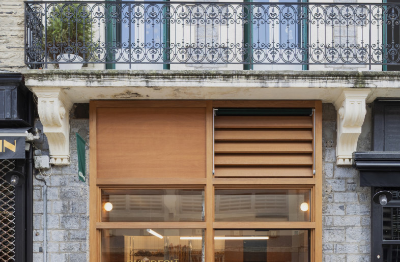 The warm plywood finish added to the shopfront help the storefront stand out on the street. - Emmy Martens
