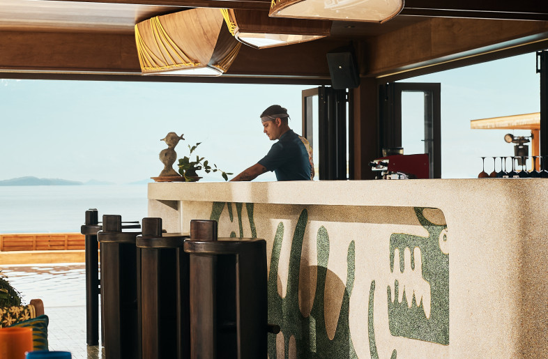 The bar takes center stage, exposed and engaged with both on-ground and in-water drink flows. - Pichan Sujaritsatit