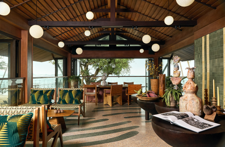 Lounging area on upper floor with extensive openings benefiting from local tropical winds and natural light. - Pichan Sujaritsatit