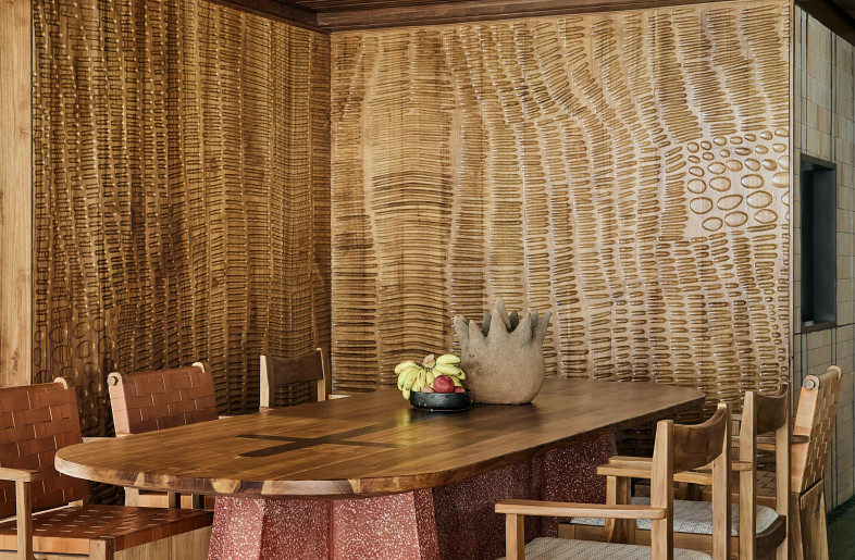 Communal tables with terrazzo legs complement the consistent materiality of the interior space. - Pichan Sujaritsatit