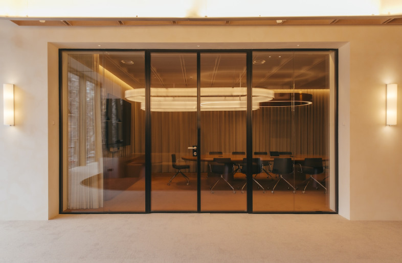 Three thematic meeting rooms translate corporate values into spatial experiences. The ‘Excellence’ room employs warm tones and natural wood to create domestic comfort with professional sophistication. - Pablo Algaza