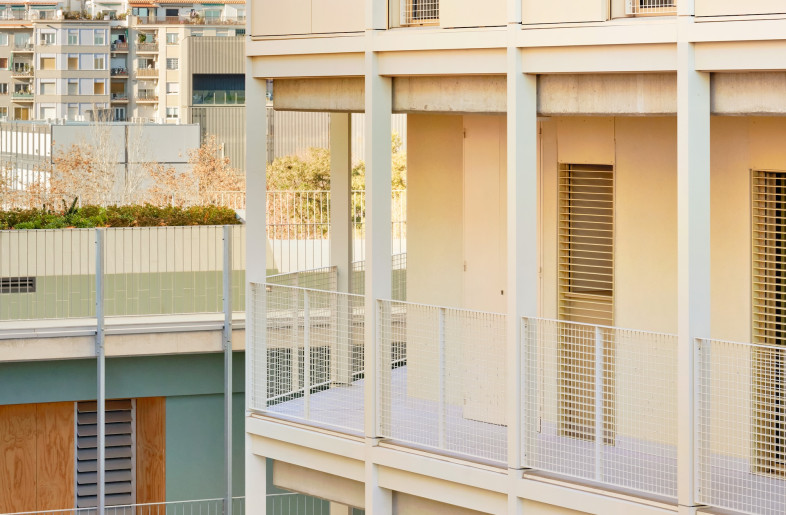 Exterior walkways border the building's courtyard. - José Hevia