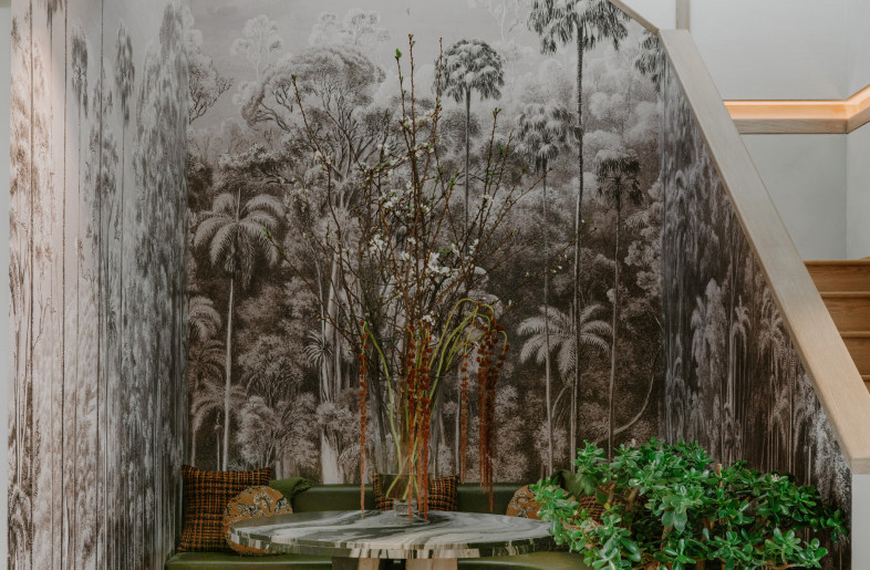 Functional seating nook under open stairwell with custom safari mural - Teal Thomsen
