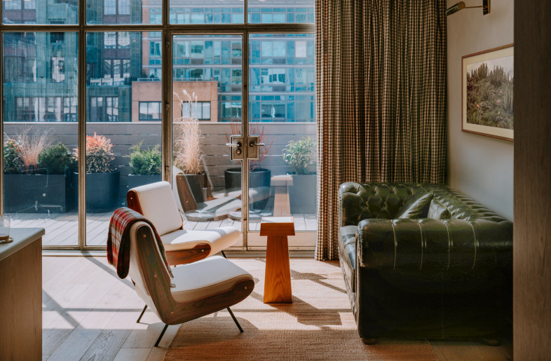Open office lounge off of outdoor patio on main level. - Teal Thomsen