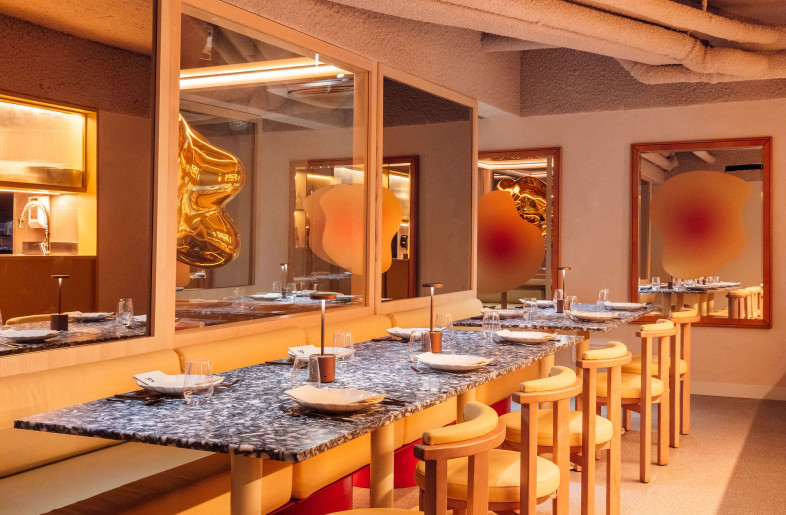 On the lower level—home to the golden popcorn sculpture—the dining area adapts through rotatable wall panels, allowing the space to shift seamlessly between intimate settings and larger group gatherings. A mirrored rhythm of textures and colors ties it all together. - Francisco Nogueira