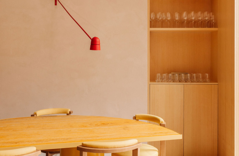 A custom sharing table, designed as two halves of a pizza—mirroring the menu’s convivial spirit. Its sculptural form and circular base support group dining while anchoring the room’s playful geometry. - Francisco Nogueira