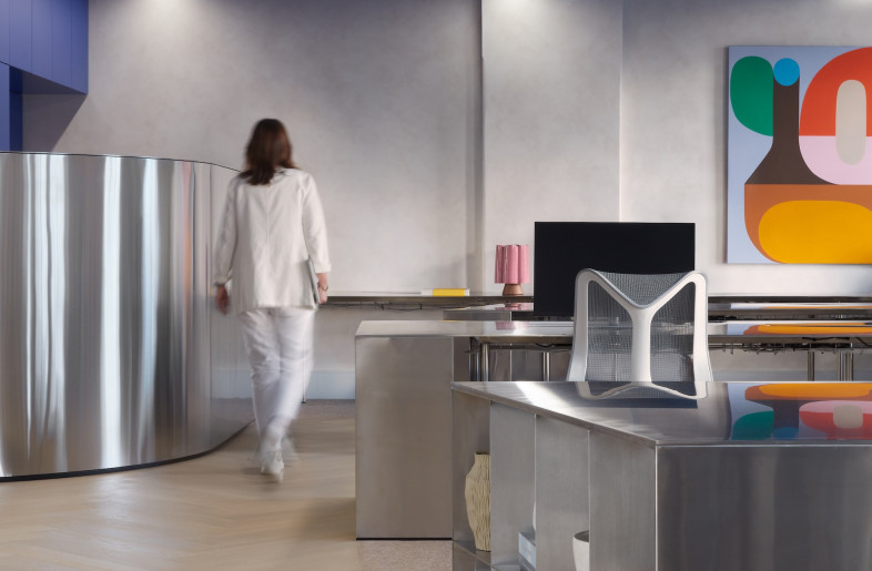 Desks are also made of steel with an undulating edge that mirrors the room divider. - Luc Remond