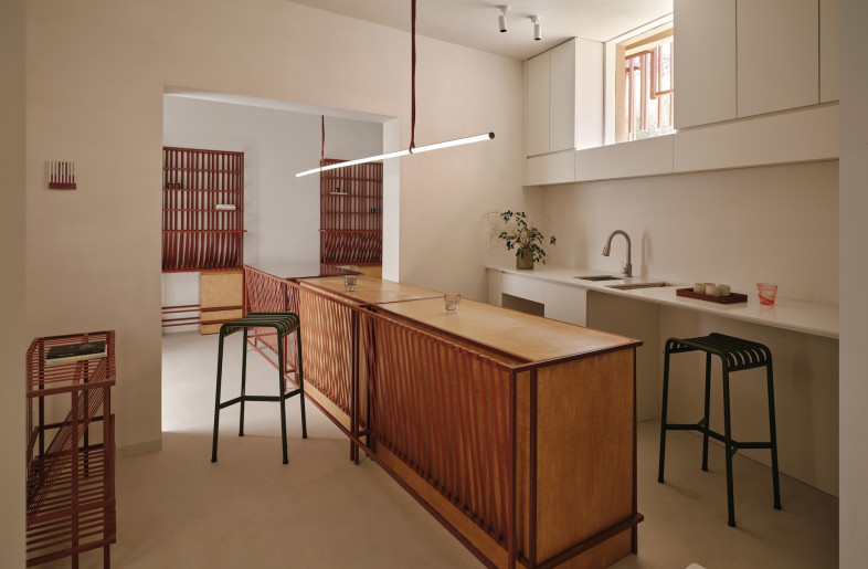 Custom furniture, constructed with steel frames wrapped in red tensioned straps, for the café and shop extends the weaving theme. - Jonathan Leijonhufvud
