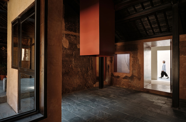 The journey begins in an adjacent rammed-earth prologue hall that preserves the original village aesthetic before visitors enter the contemporary museum spaces. - Jonathan Leijonhufvud
