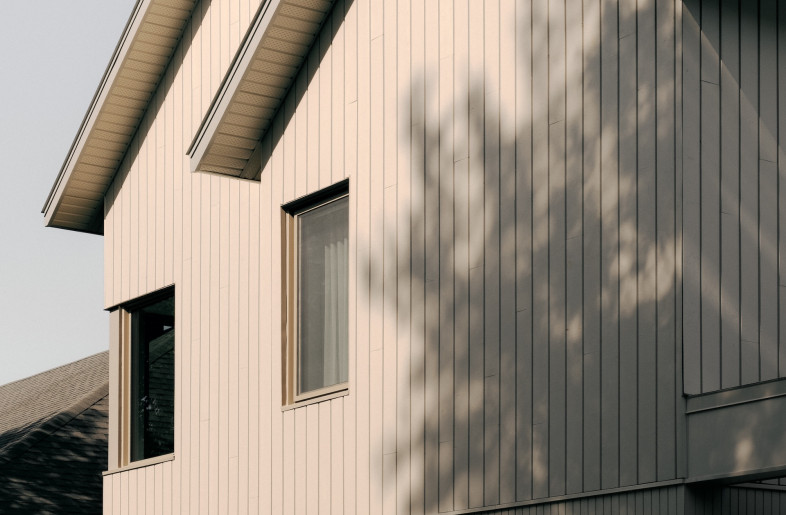 The exterior of Pied-de-vent Residence features wooden slat cladding of varying widths, demarcating a double garage from the house while reducing the overall mass. - Felix Michaud