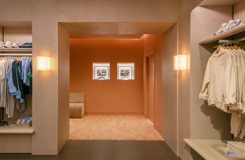 A hall leads towards a curtained, carpeted dressing area. - Courtesy of Universal Design Studio