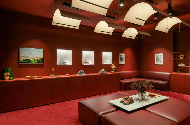 The 'Made in U.K.' section of the store bathes the visitor in a toasty red. The space is also meant to host special celebrations. - Courtesy of Universal Design Studio