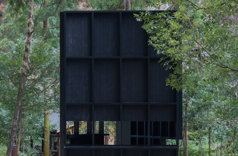 The pavilion is located alongside a mountain trail, creating a small space to rest and take shelter in the rain. - Aptdotapt