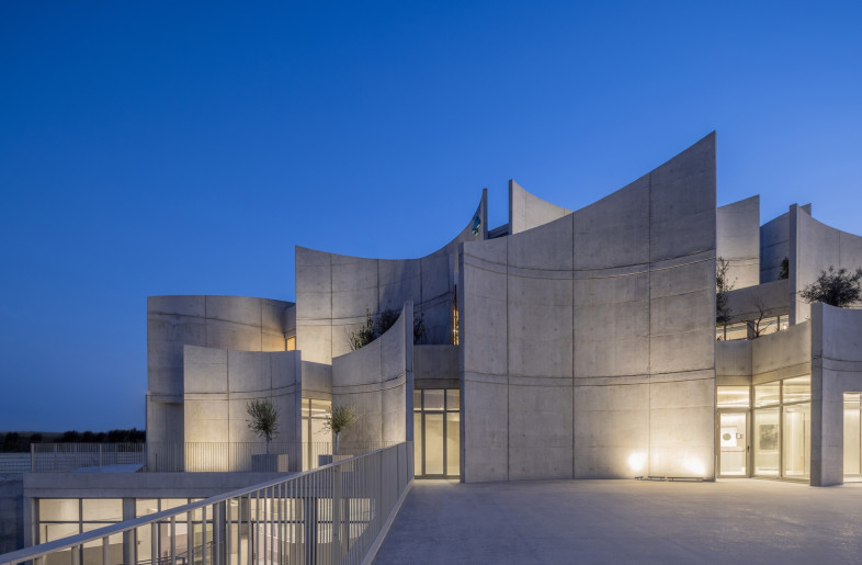 Brutalist concrete takes shape in a decidedly un-brutalist way with gently curving walls that overlap like sculpture. - Leonit Ibrahimi