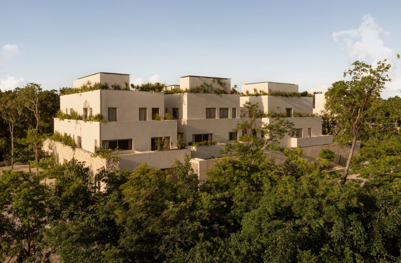 The architecture anticipates and incorporates an eventual growing together, using cascading planters that encourage vegetation to spill down façades and terraces designed to age gracefully alongside their jungle surroundings. - Ariadna Polo