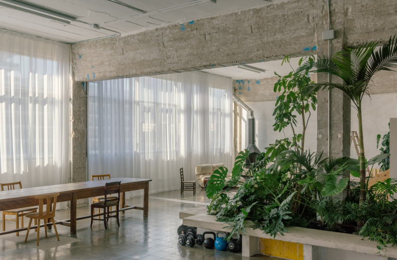 Technical systems – exposed installations, lightweight partitions, heavy concrete elements and visible storage – celebrate the warehouse's industrial heritage. - Simone Marcolin