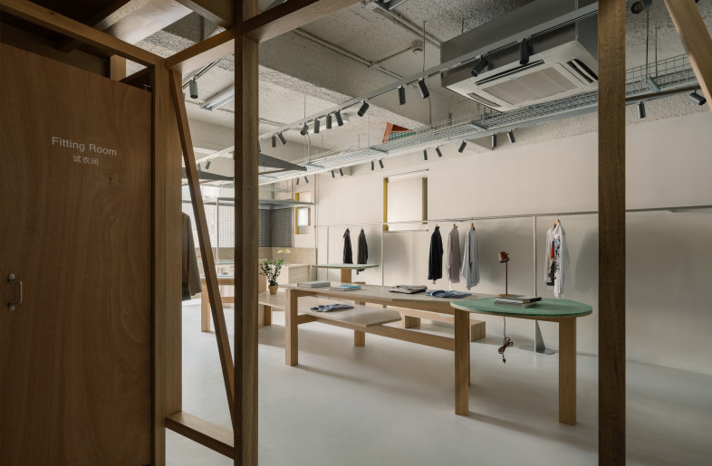 Inside, timber framing and metal sheds create a sort of cityscape against which books, shoes and garments pop. - Wen Studio