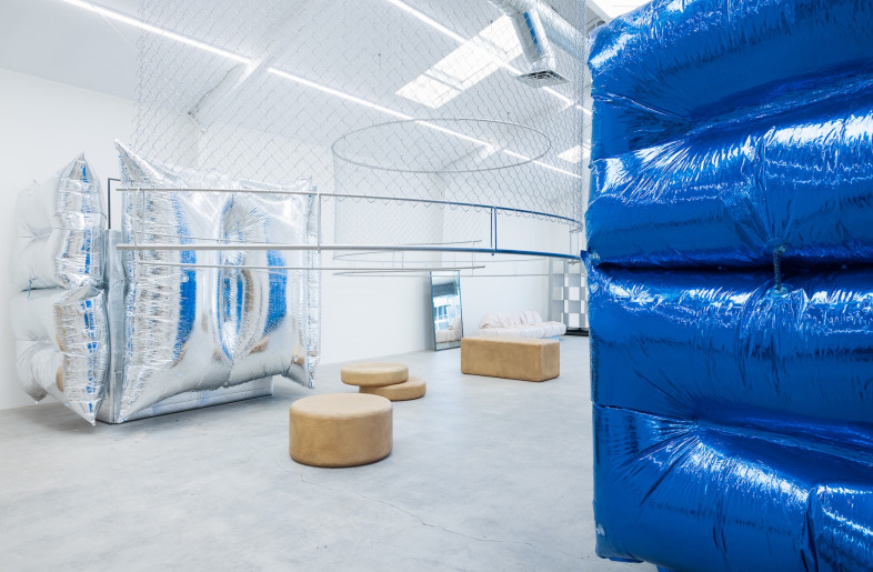 Blue and silver foiled inflatable structures, which Studio O employed at Mode Shanghai in 2020, reappear as fitting rooms. - Gian Barbarona