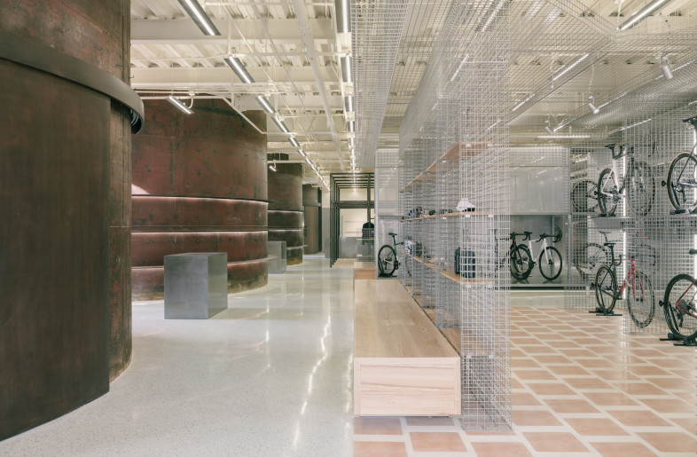 Display units are modular, allowing the retail layout to evolve with product cycles, while furnishings, including Artek seating and Yatofu-designed bar stools, add domestic warmth. - Wen Studio