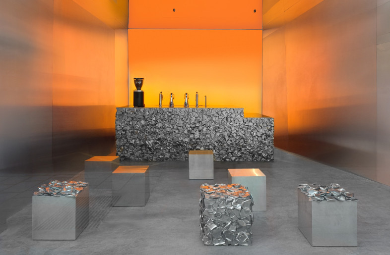 The illuminated wall creates the dominant colour story, maintaining Café Nuances' signature palette while creating a backdrop that pulses with energy. - Courtesy of Crosby Studios