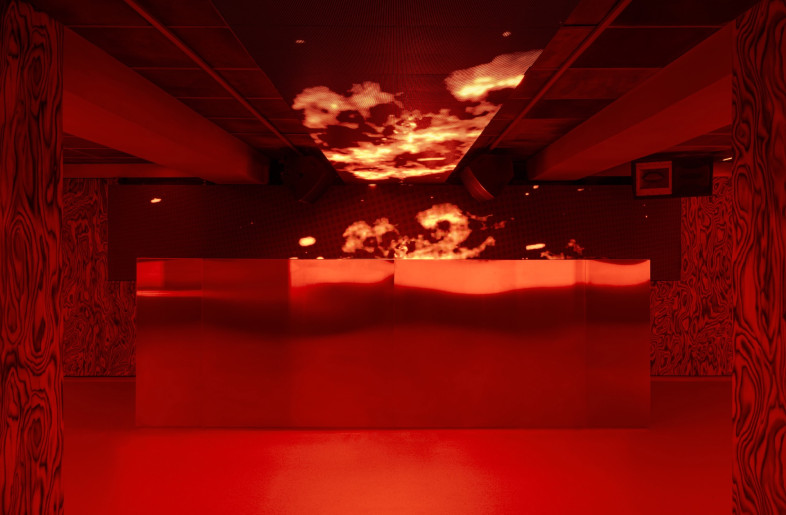 A screen behind the DJ booth plays visualizers throughout the night. - Simone Marcoli