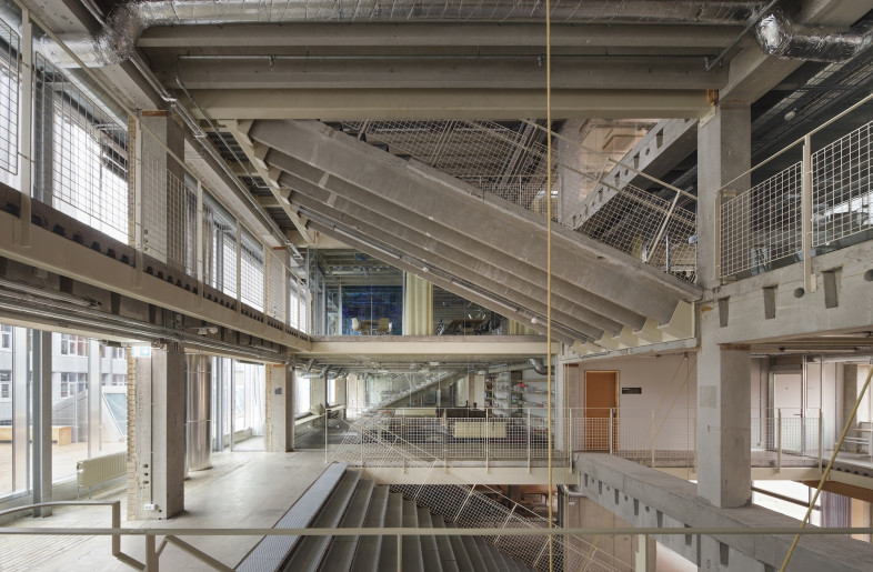 The interior is a patchwork of recycled materials and structural clarity. - Hampus Berndtson