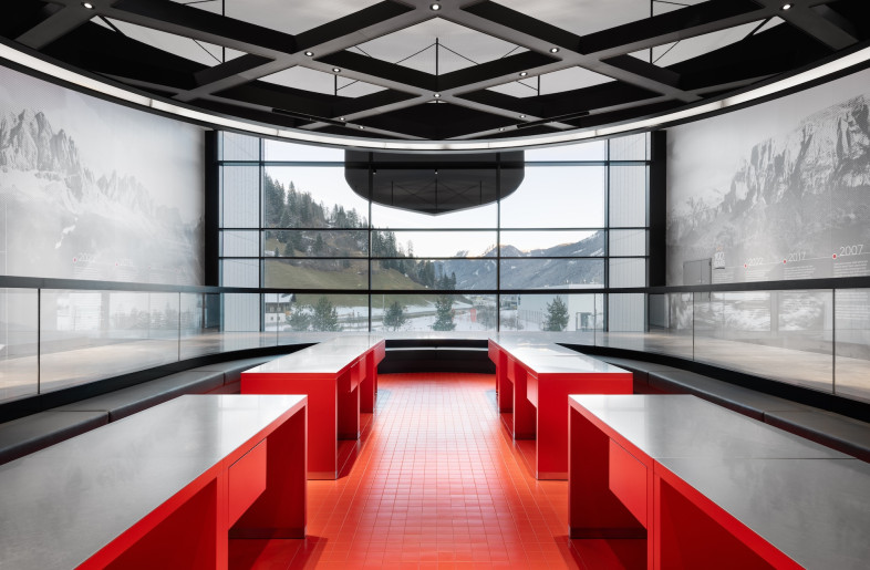 The wafer motif is sprinkled throughout: a coffered wood ceiling in the café echoes the wafer’s grid, while a warm beige palette and latticed, waffle-like forms – seen in interwoven timber façade and the black millwork of the upstairs viewing platform – reinforce the theme. - Marco Cappelletti
