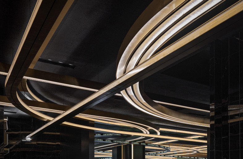 Upon stepping into the lobby, you can see that the long light strips on the ceiling are stacking on top of each other in layers. They connect from afar until up front continuously. - Jonathan Leijonhufvud Architectural Photography