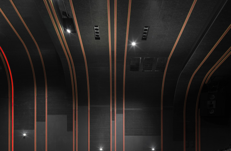 The light strips are replaced with red LED screens displaying information of the showing movies. The lights of the steps are also in red colour so to unify the lights of the cinema, thus creating a clean and unique space. - Jonathan Leijonhufvud Architectural Photography