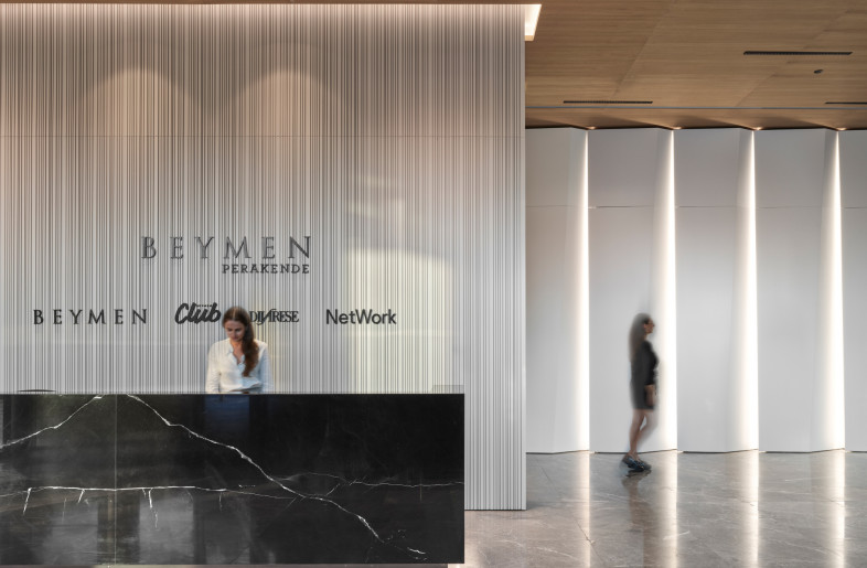 Upon entrance to the building the visitor is welcomed at the reception desk the facade of which is made of marble and the backdrop is a bespoke laquered MDF panel. - Photo by Ibrahim Ozbunar https://www.ibrahimozbunar.com/