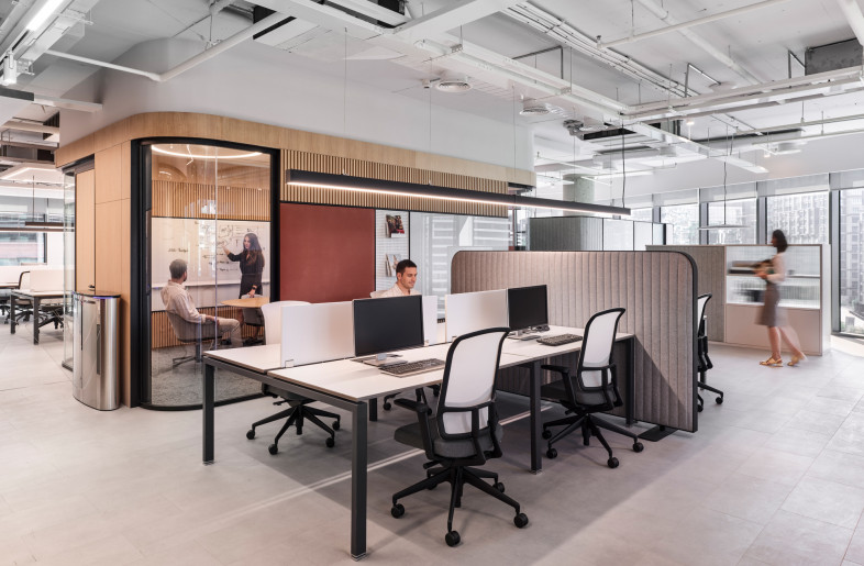 In the open office the zoning and good acoustical performance are ensured by the bespoke free-standing acoustic partitions.  Writable walls and textile panels for pin-notes are integrated in the cladding of the meeting room partition. - Photo by Ibrahim Ozbunar https://www.ibrahimozbunar.com/
