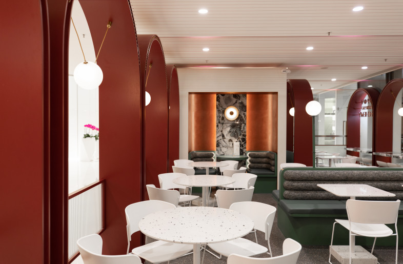 A large circular structural column occupied a corner of the external seating area. Metagram increased the mass of this element and squared it off to both mimic the geometry of the arches and to provide a strong 'backdrop' which oriented the space back toward the main tenancy space. Plastered in a rich coat of venetian plaster this 'backdrop' provided a wonderful opportunity to create an intimate seating nook for two. - Metagram