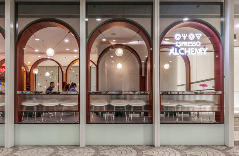 The scale and design of the arches fit seamlessly into the existing architecture, using the company's brand colour to contrast the surroundings. This single element brings into alignment the common mall, tenancy, surrounding architecture and the cafe's brand identity. - Metagram