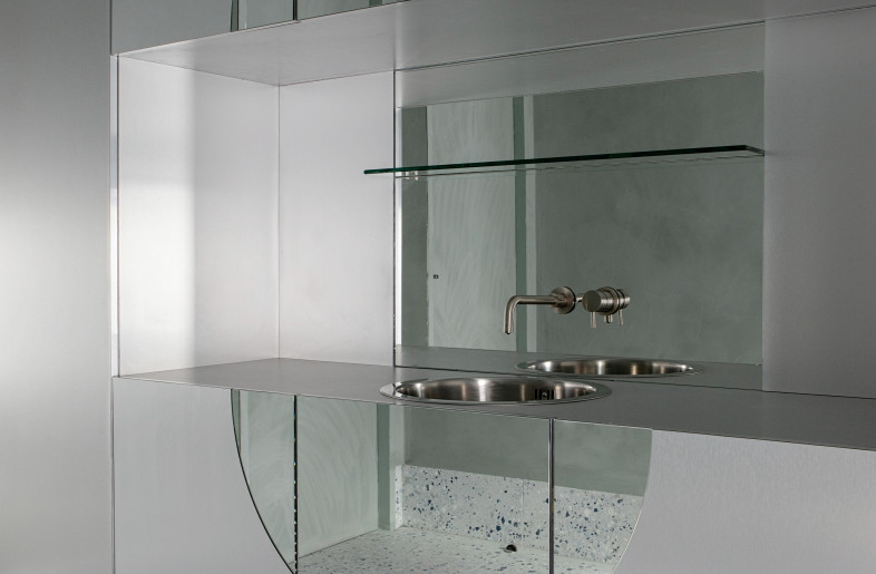 The treatment rooms needed to be highly clinical, sterile and very easy to keep clean. Hygiene was of the utmost importance to the client. We wanted to find a balance so that it didn’t feel cold and unwelcoming. The lozenge shapes disrupt the clean lines and add a softness of sorts. We added subtle colour changes in the rooms, bringing in a blue tone to the terrazzo and a hint of green into the textured plaster walls and ceilings, mirror brightening and expanding the spaces. A seamless, full height wall of walnut contrasts against the steel cabinetry and warms up the upper floor more. - Photo by Ruth Maria Murphy. Design by Kingston Lafferty Design