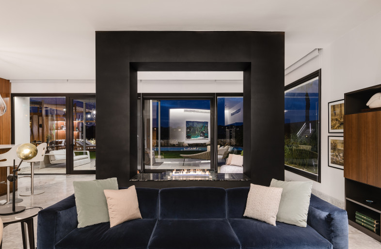 An accent fireplace that frames the outdoor view and adds warmth and coziness to this formal living space. - Nour El Refai (Photography)