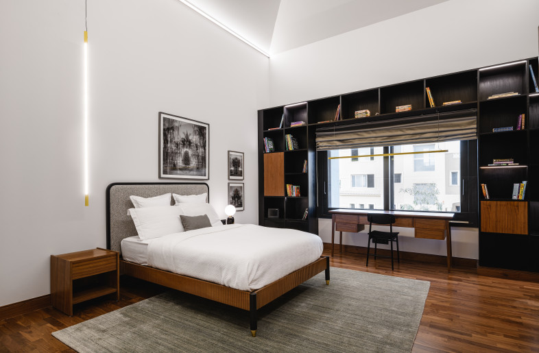 A stylish yet simple bedroom featuring quirky lighting and local photography art; perfect for a teenage boy. - Nour El Refai (Photography)
