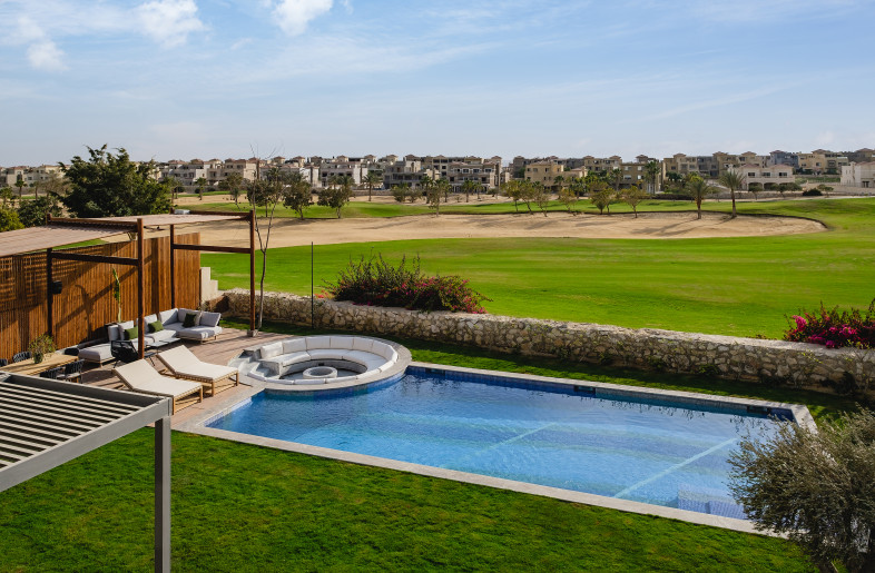 The great landscape is observed from the living room balcony along with the custom pool tile design that is modern, unique and bold. - Nour El Refai (Photography)