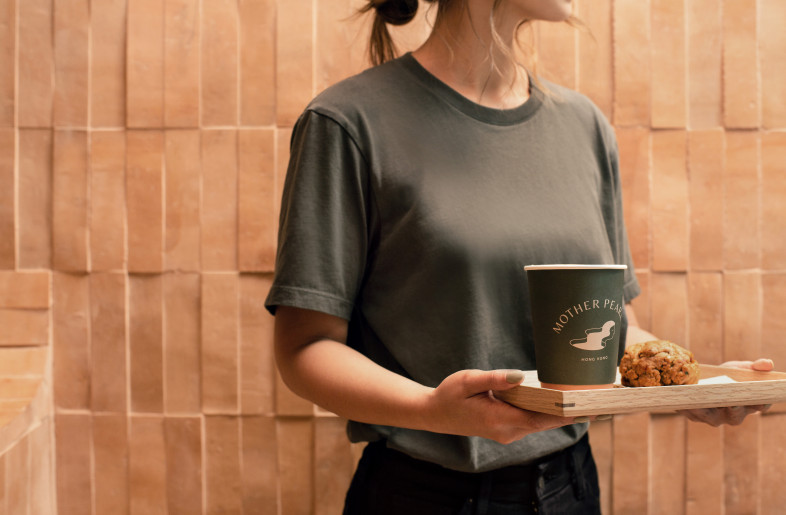 Like the biodegradable napkins and cups featuring variations of Mother Pearl logo, every customer touchpoint speaks to their commitment to do good for the health of us and our planet. - Photographer: Amanda Kho
