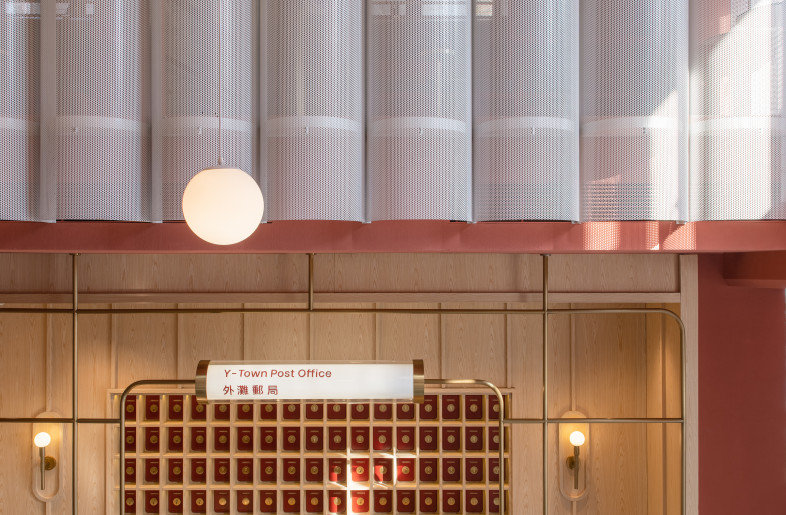 The Post Office counter and checkout desk is inspired by the nostalgia of wood panels and custom brass fixtures. - Photo Credit: Wen Studio