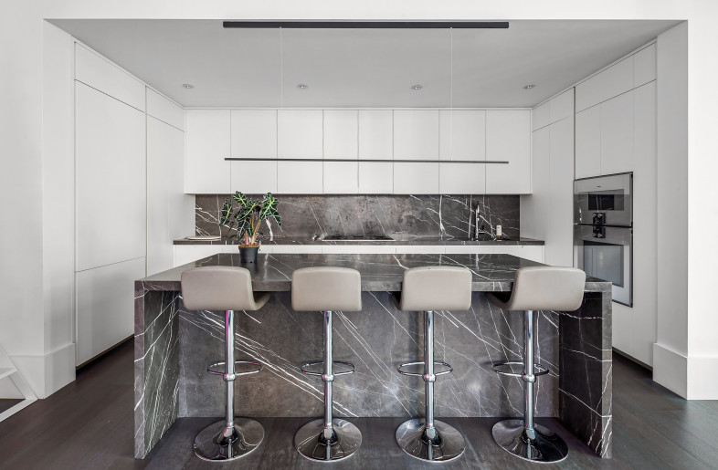 Custom kitchen by Poliform with stone-clad center island - Evan Joseph