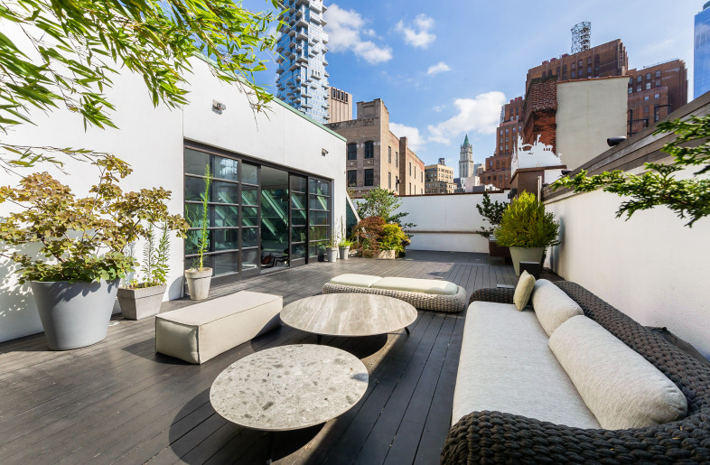 The Ipe-planked outdoor terrace with lounge areas and an outdoor shower set against the backdrop of the TriBeCa skyline - Evan Joseph