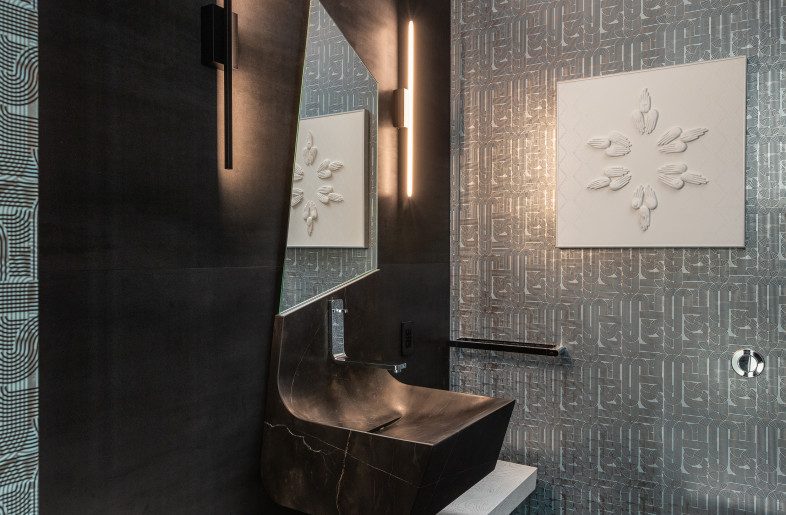 Marble detailed ensuite bathroom with sculptural sink - Evan Joseph