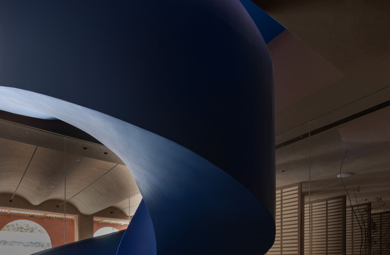 Spiral-encircled staircase: This dazzling blue, together with the bright light, injects a subtle sense of difference into the entire space. Like a school of fish diving in the deep sea, it is full of extreme beauty and vitality. - Yun Ouyang